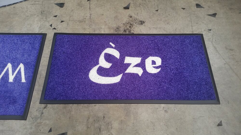 Purple doormat with white Èze lettering