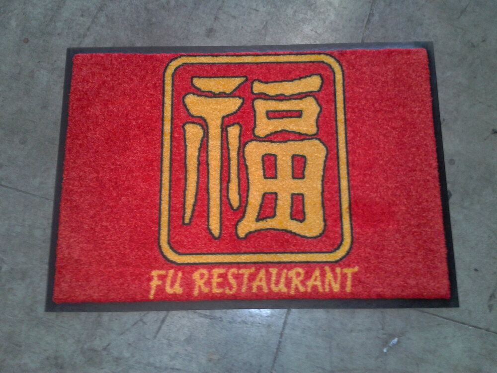 Red doormat with a gold Chinese good-fortune character