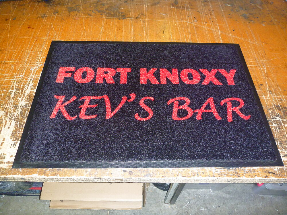 Black Fort Knoxy Kev’s Bar home bar mat with red lettering