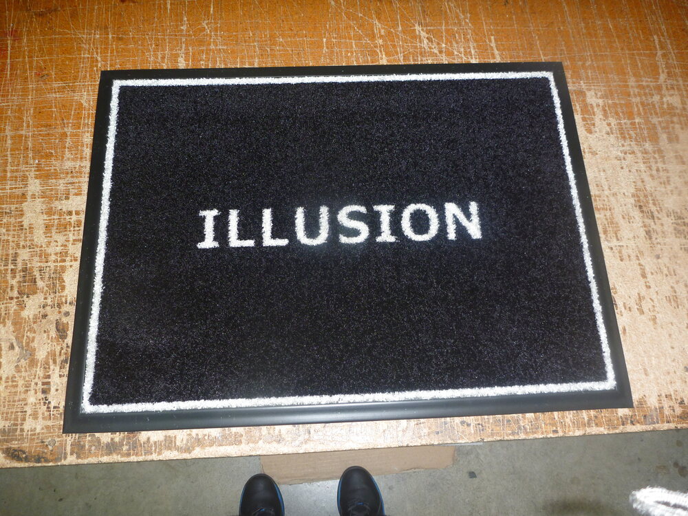 Black Illusion doormat with white lettering and border