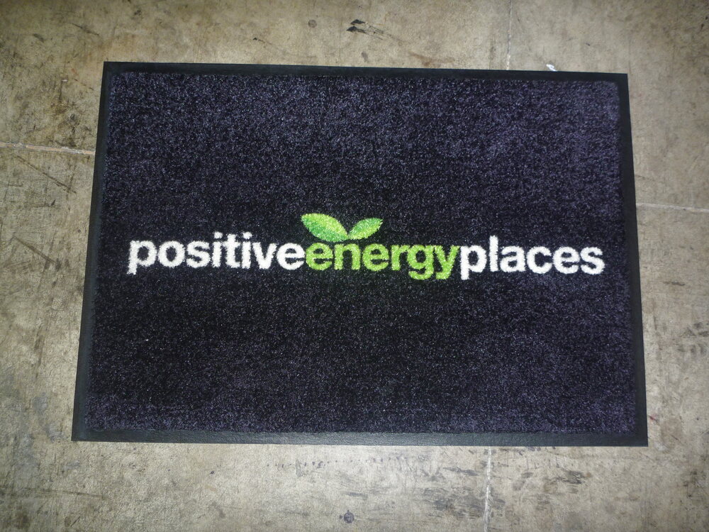 Black positive energy places logo doormat