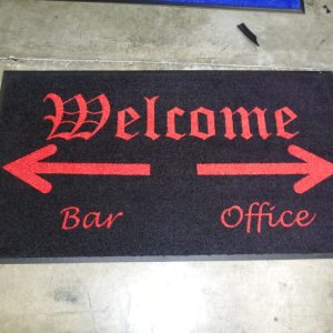 Black welcome mat with red arrows pointing to Bar and Office