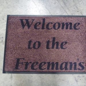 Brown family name welcome mat reading Welcome to the Freemans