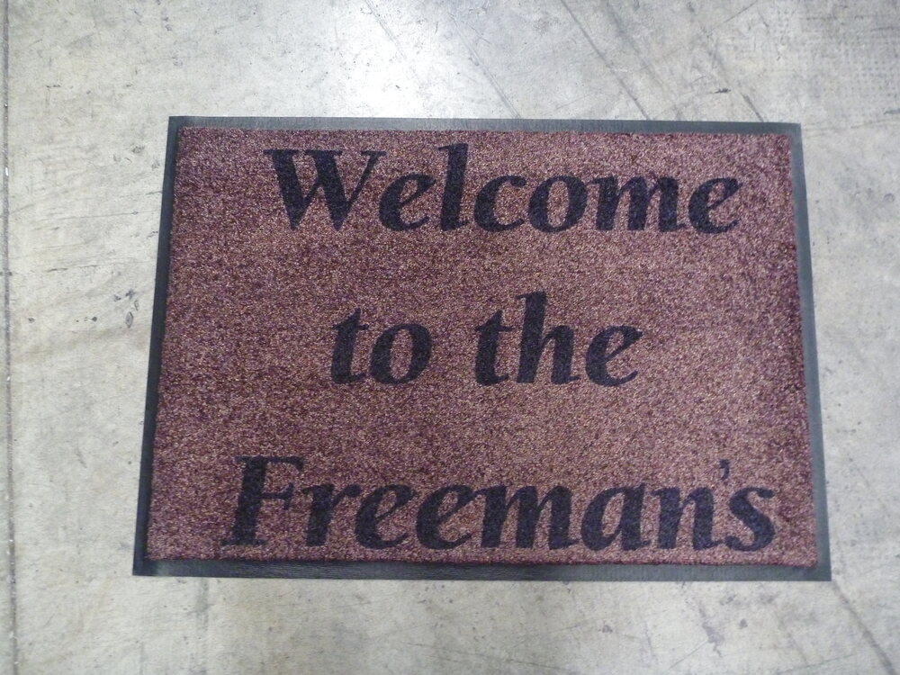 Brown family name welcome mat reading Welcome to the Freemans